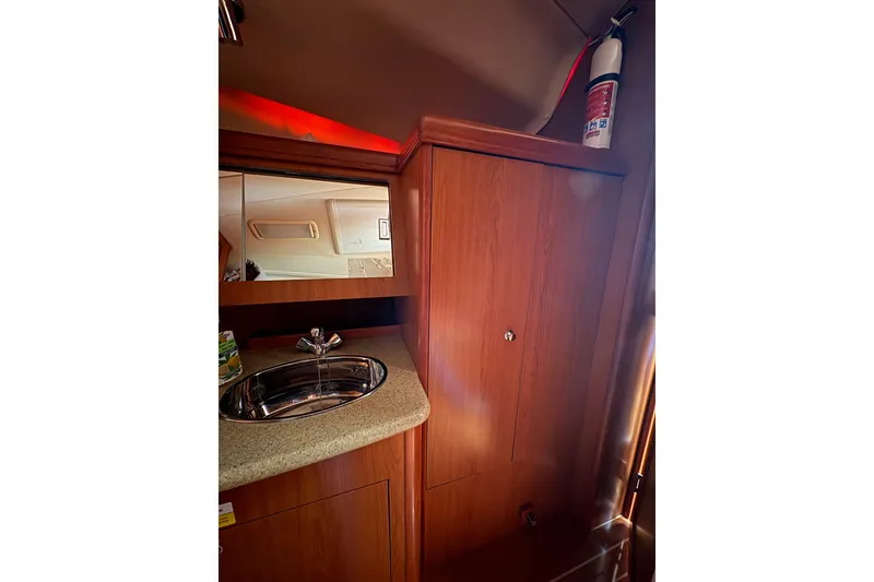 Slide: The Image of Interior of 2009 Hunter 41 Deck Salon with sink, mirror, and fire extinguisher. - 83