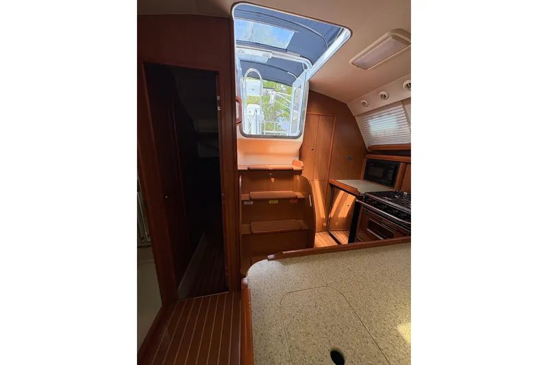 Slide: The Image of Interior of 2009 Hunter 41 Deck Salon yacht with modern kitchen and skylight. - 87