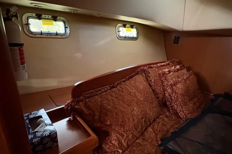 Slide: The Image of Cozy cabin interior of 2009 Hunter 41 Deck Salon with decorative pillows and portholes. - 88