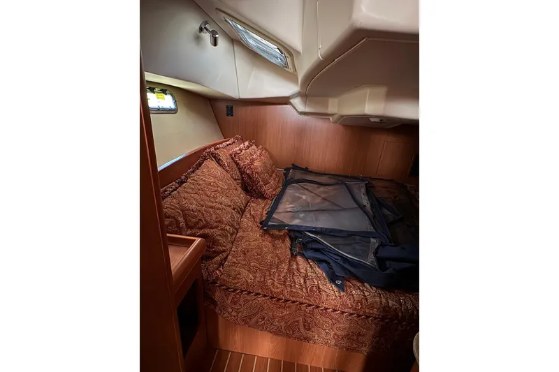 Slide: The Image of Cozy cabin interior of 2009 Hunter 41 Deck Salon with elegant bedding and wood finish. - 89