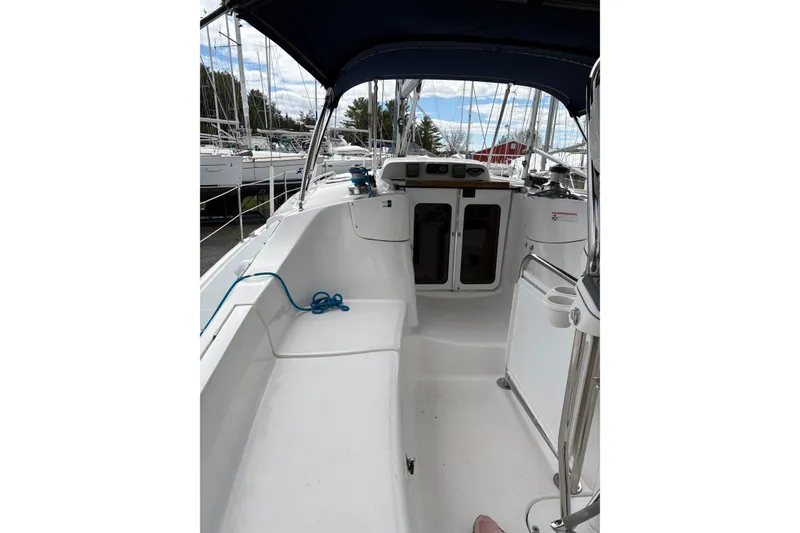 Slide: The Image of 2009 Hunter 41 Deck Salon sailboat cockpit with seating and navigation equipment. - 9