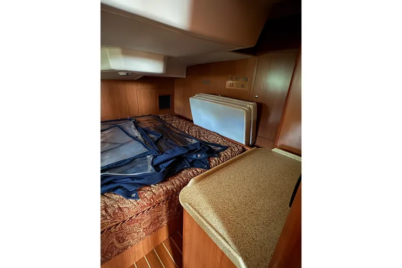 Slide: The Image of Interior of 2009 Hunter 41 Deck Salon with wood finish and bedding. - 91