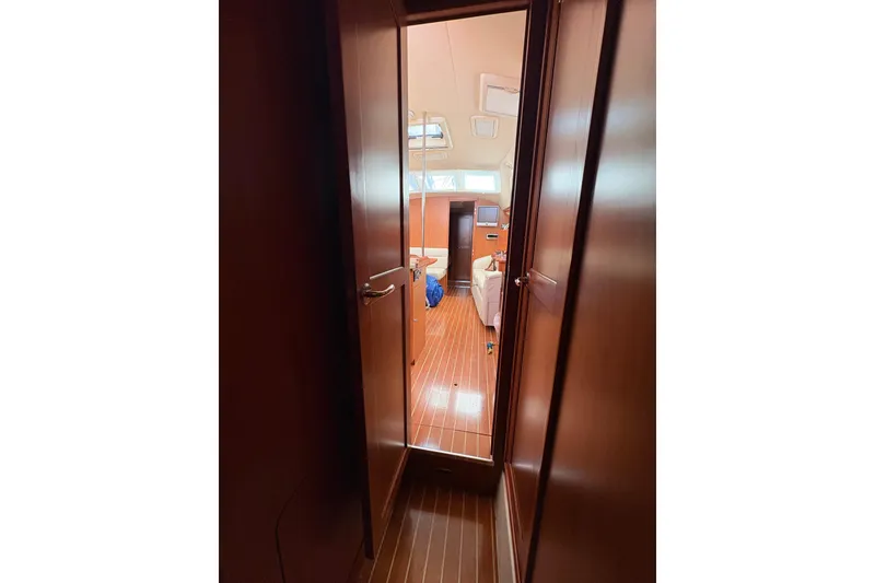 Slide: The Image of Interior view of 2009 Hunter 41 Deck Salon yacht, featuring wooden flooring and cozy cabin. - 94