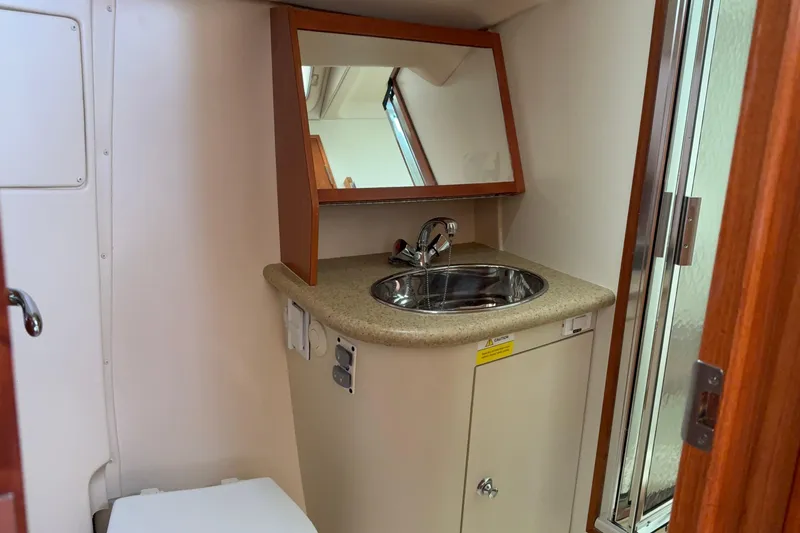 Slide: The Image of 2009 Hunter 41 Deck Salon bathroom with sink, mirror, and shower. - 97
