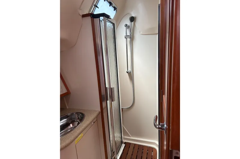 Slide: The Image of 2009 Hunter 41 Deck Salon bathroom with shower, sink, and wooden accents. - 98