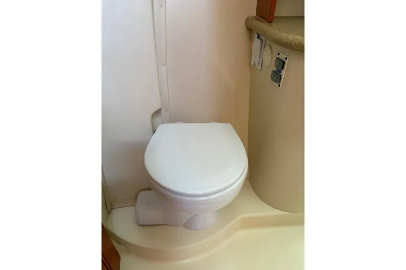 Slide: The Image of Toilet in 2009 Hunter 41 Deck Salon yacht bathroom, featuring compact design and beige interior. - 99