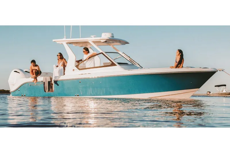 The Image of Manufacturer Provided Image: 2026 Edgewater 262CX Crossover boat on water with people enjoying the sun. - 0