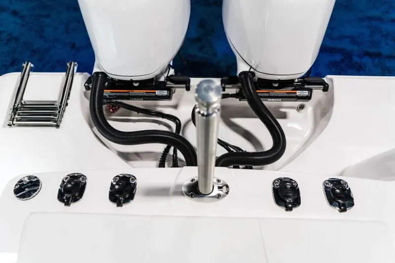 Slide: The Image of Manufacturer Provided Image: 2026 Edgewater 262CX Crossover boat engines and controls, featuring dual outboard motors. - 11