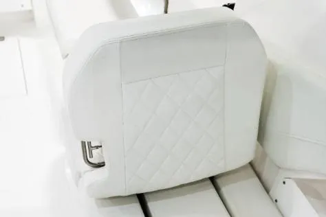 Slide: The Image of Manufacturer Provided Image: White cushioned seat on 2026 Edgewater 262CX Crossover boat, featuring diamond stitching. - 13
