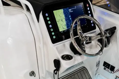 Slide: The Image of Manufacturer Provided Image: 2026 Edgewater 262CX Crossover boat dashboard with navigation display and steering wheel. - 4