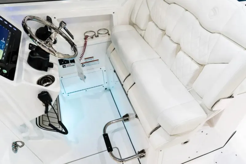 Slide: The Image of Manufacturer Provided Image: 2026 Edgewater 262CX Crossover boat interior with white seating and modern steering console. - 5