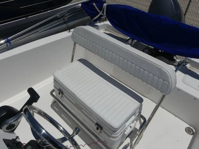 Slide: The Image of Interior of a 2018 Release 180 RX boat with white seating. - 12