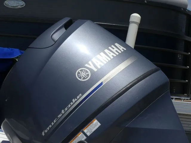 Slide: The Image of Yamaha outboard motor, four-stroke, mounted on a boat. - 8
