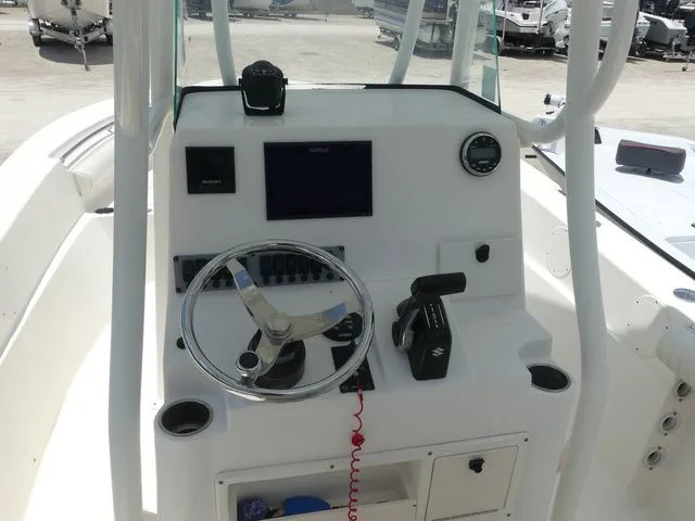 Slide: The Image of 2019 Sea Born LX24 Center Console helm with steering wheel and instruments. - 18