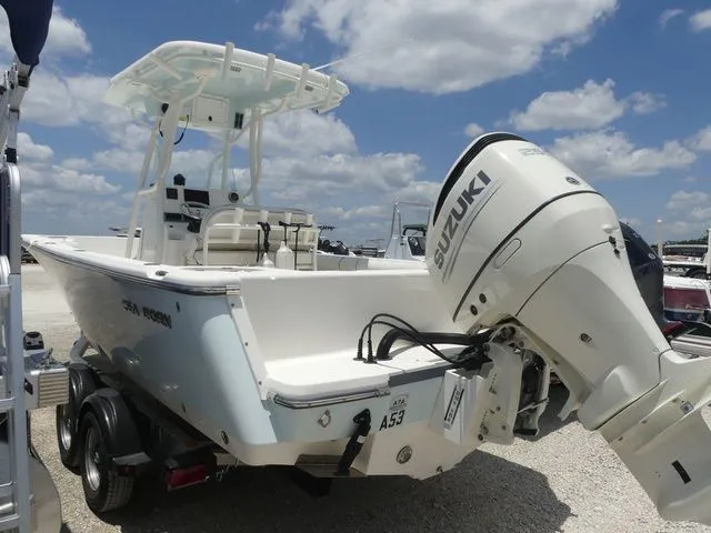 Slide: The Image of 2019 Sea Born LX24 Center Console with Suzuki engine outdoors. - 6