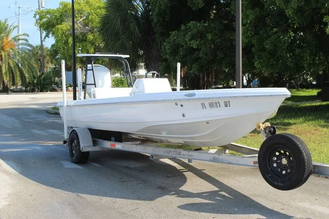 The Image of 2005 Action Craft 1890 Flatmaster boat on trailer outdoors. - 1