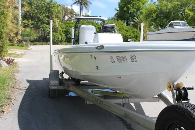 Slide: The Image of 2005 Action Craft 1890 Flatmaster boat on trailer outdoors. - 4