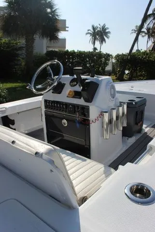 Slide: The Image of 2005 Action Craft 1890 Flatmaster boat console with palm trees in the background. - 46