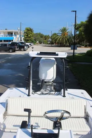 Slide: The Image of 2005 Action Craft 1890 Flatmaster boat parked with palm trees. - 49