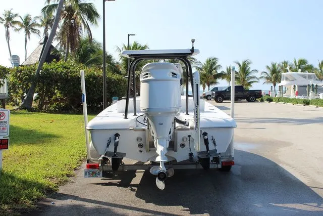 Slide: The Image of 2005 Action Craft 1890 Flatmaster boat on trailer, palm trees in background. - 7