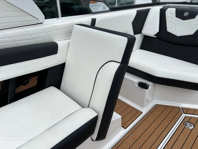 Slide: The Image of Interior of 2021 Nautique G23 with white and black seating. - 22