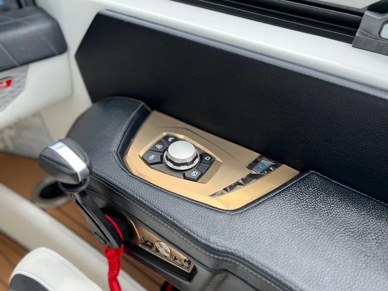 Slide: The Image of 2021 Nautique G23 control console with controls. - 25
