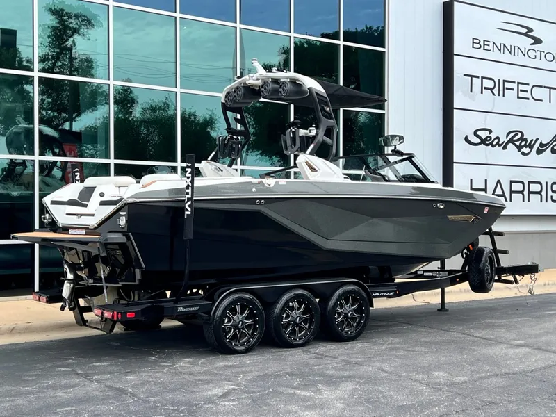 Slide: The Image of 2021 Nautique G23 boat on trailer in front of building. - 3