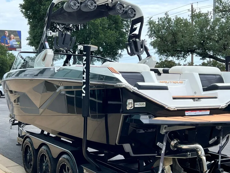 Slide: The Image of 2021 Nautique G23 boat on trailer, side view. - 6