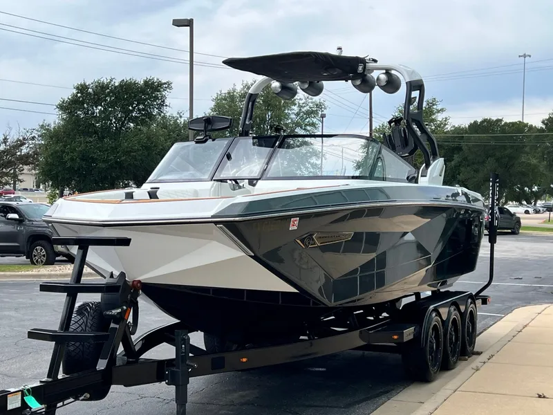 Slide: The Image of 2021 Nautique G23 boat parked on a trailer outdoors. - 7