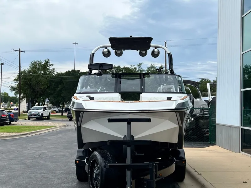 Slide: The Image of 2021 Nautique G23 boat on a trailer in front of a building. - 8