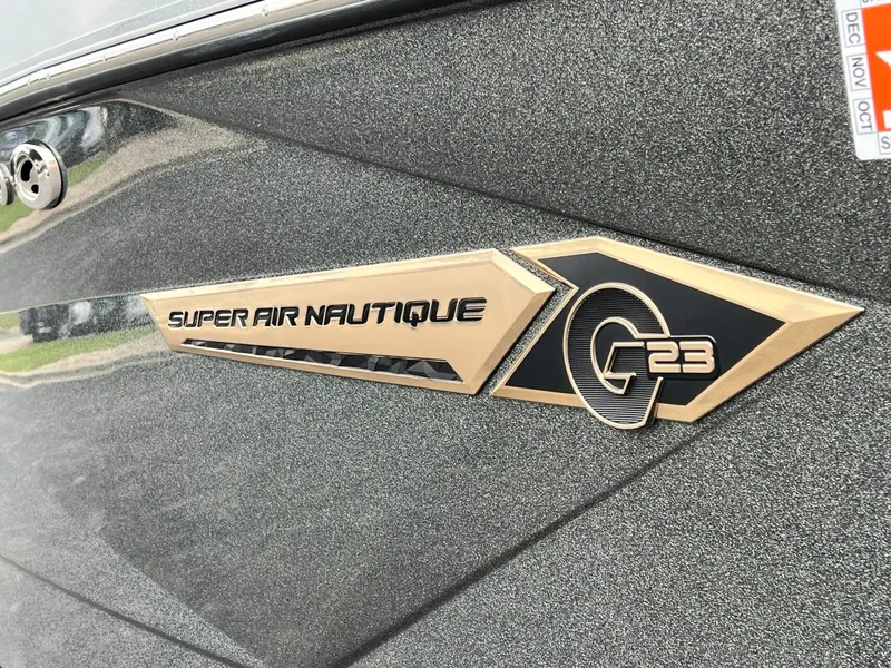Slide: The Image of Close-up of 2021 Nautique G23 boat emblem. - 9