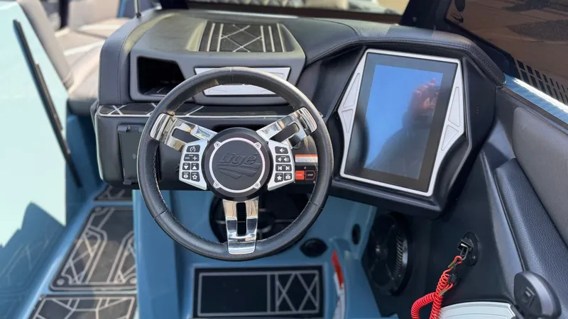 Slide: The Image of Interior of 2022 Tigé 25ZX with steering wheel and touchscreen. - 10