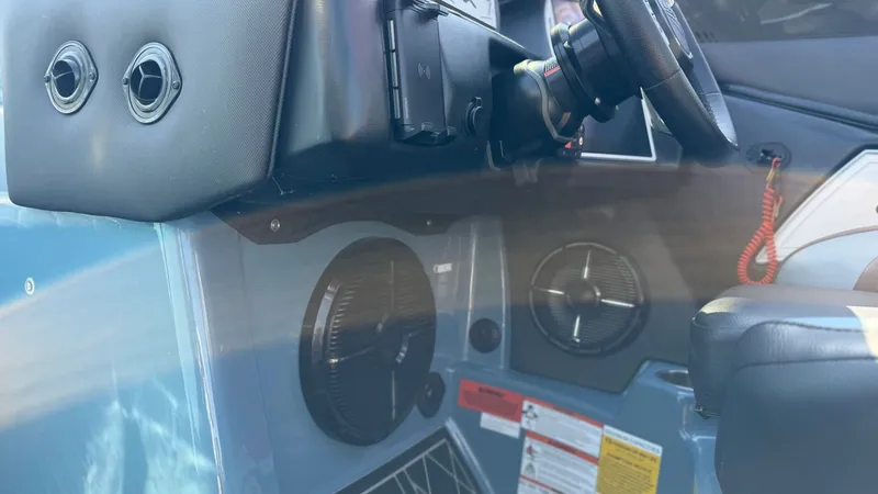 Slide: The Image of Interior view of 2022 Tigé 25ZX with steering wheel and speakers. - 11