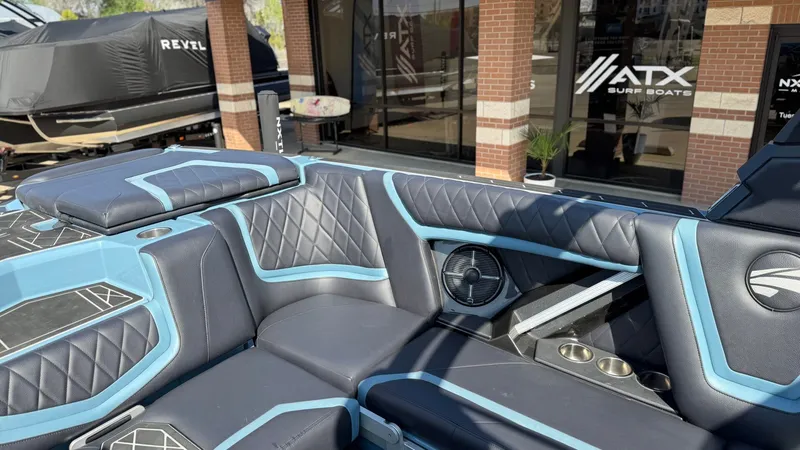 Slide: The Image of Interior of a 2022 Tigé 25ZX boat with blue and black upholstery. - 22