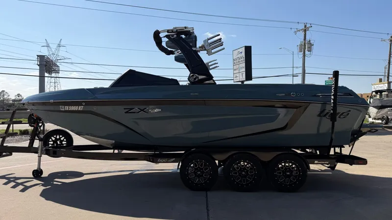 Slide: The Image of 2022 Tigé 25ZX boat on trailer, side view. - 6
