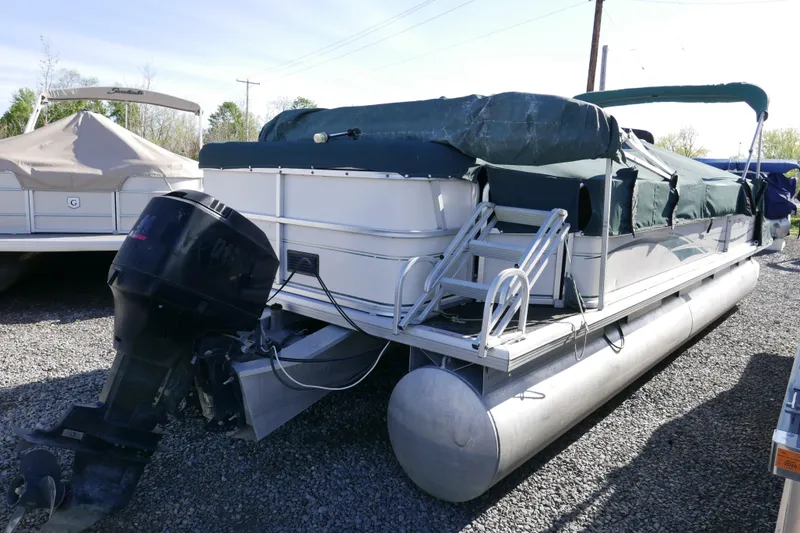 Slide: The Image of 2004 Sun Tracker Party Barge 240 pontoon boat with covered seating and outboard motor. - 4
