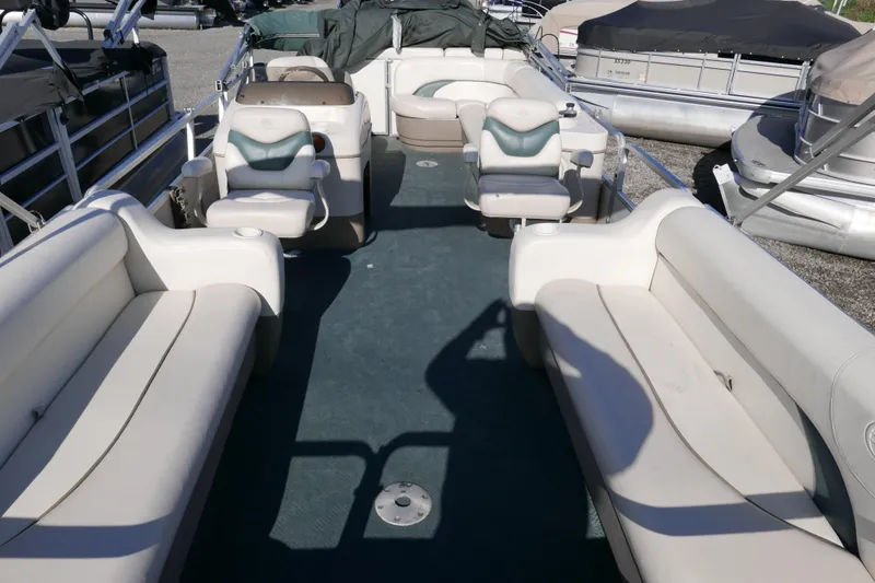 Slide: The Image of 2004 Sun Tracker Party Barge 240 interior with spacious seating and helm. - 8