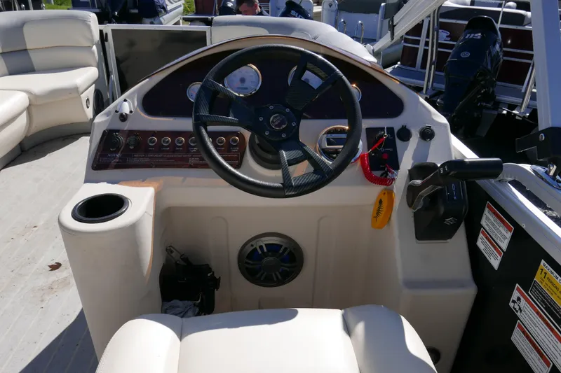 Slide: The Image of 2022 Lexington 320HPT boat dashboard with steering wheel and control panel. - 10