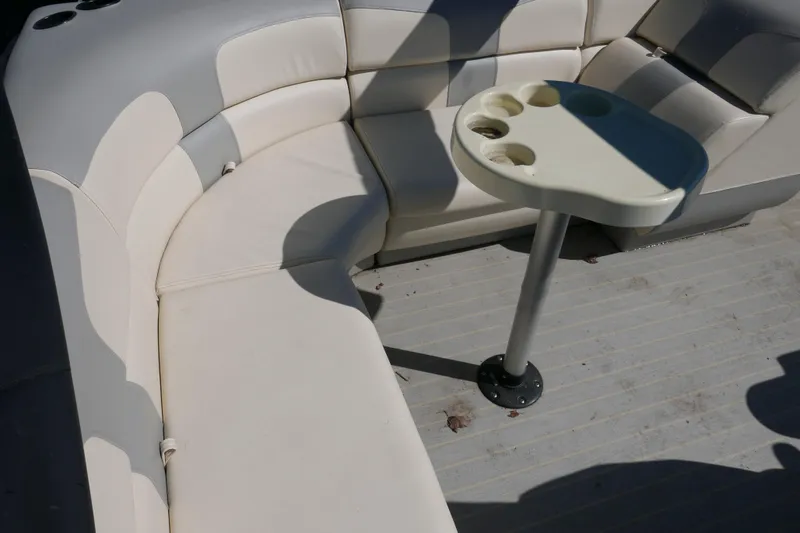 Slide: The Image of Luxurious seating area on a 2022 Lexington 320HPT boat with a convenient cup holder table. - 11