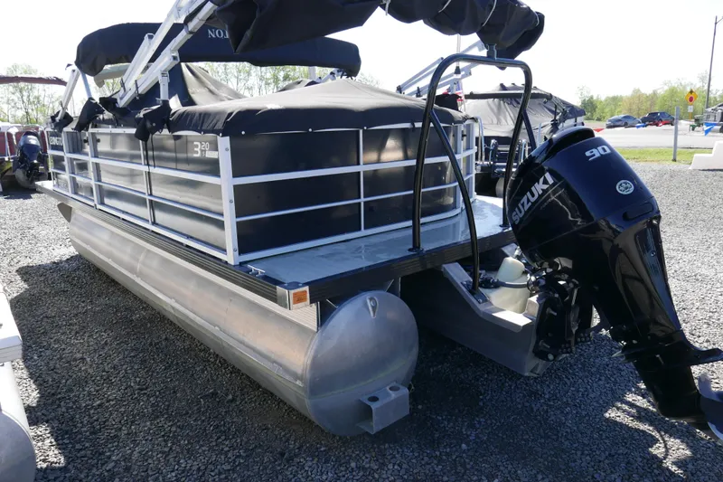 Slide: The Image of 2022 Lexington 320HPT pontoon boat with Suzuki 90 outboard motor on gravel lot. - 4