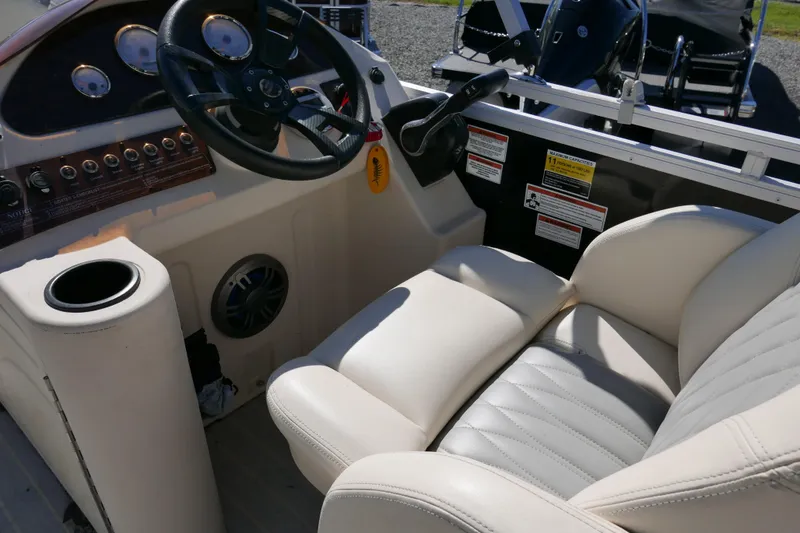 Slide: The Image of Luxurious 2022 Lexington 320HPT boat interior with steering wheel and plush seating. - 9