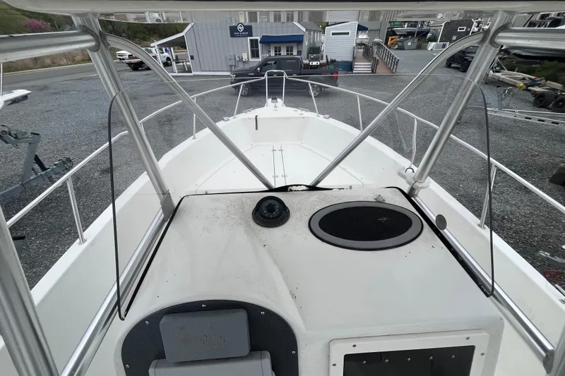 Slide: The Image of 2002 Hydra-Sports 230 CC boat interior view, showcasing helm and deck layout. - 10