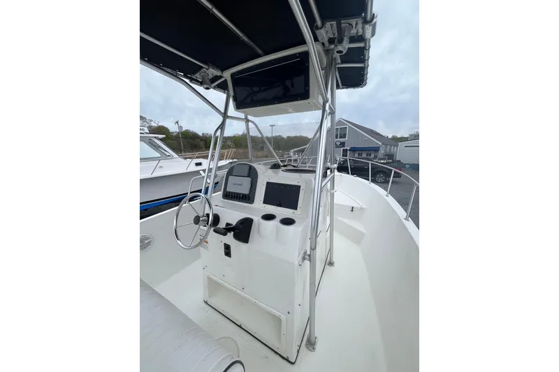 Slide: The Image of 2002 Hydra-Sports 230 CC boat console with steering wheel and navigation equipment. - 13