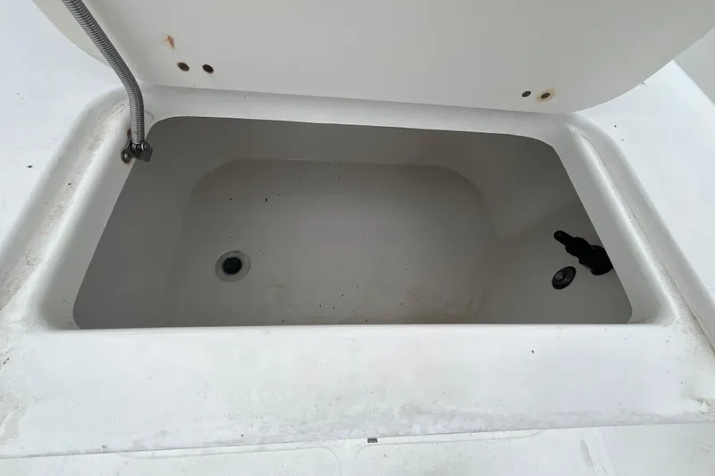 Slide: The Image of Open storage compartment on a 2002 Hydra-Sports 230 CC boat. - 14
