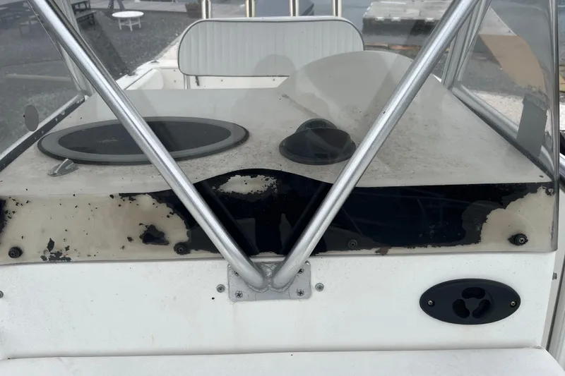Slide: The Image of 2002 Hydra-Sports 230 CC boat console with visible wear and metal framework. - 21