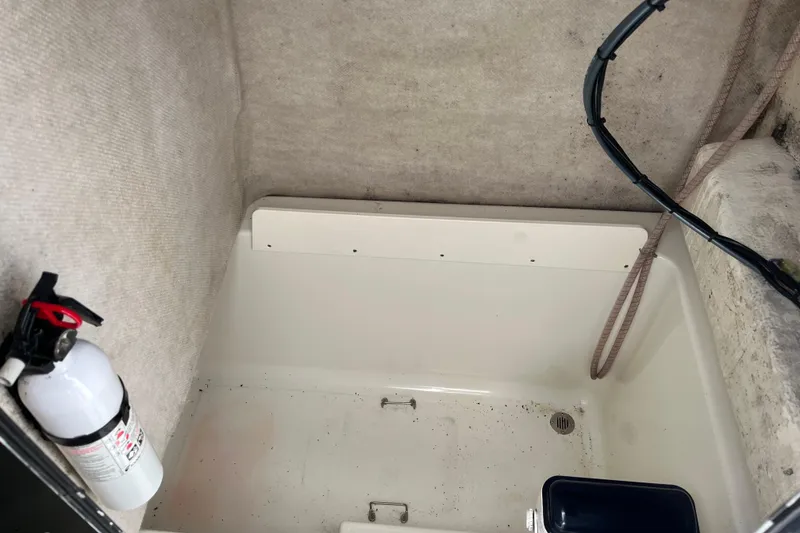 Slide: The Image of Interior of a 2002 Hydra-Sports 230 CC boat with fire extinguisher and storage compartment. - 3
