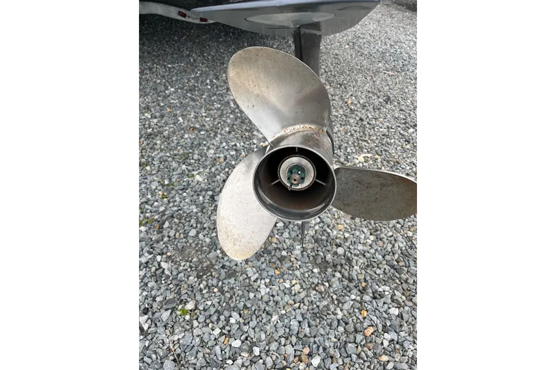 Slide: The Image of Propeller of a 2002 Hydra-Sports 230 CC boat on gravel surface. - 8