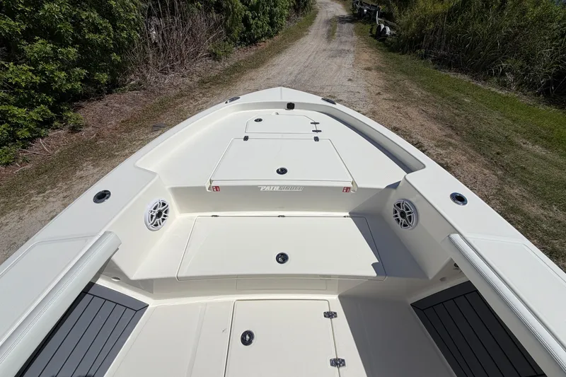 Slide: The Image of 2026 Pathfinder 2400 Open boat deck, spacious layout, white finish, outdoor setting. - 16
