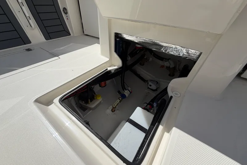Slide: The Image of Open hatch of 2026 Pathfinder 2400 Open boat, revealing internal components. - 17