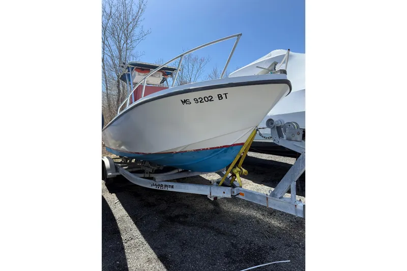 The Image of 2017 Mako 21 LTS boat on trailer, parked outdoors, with visible registration number. - 1